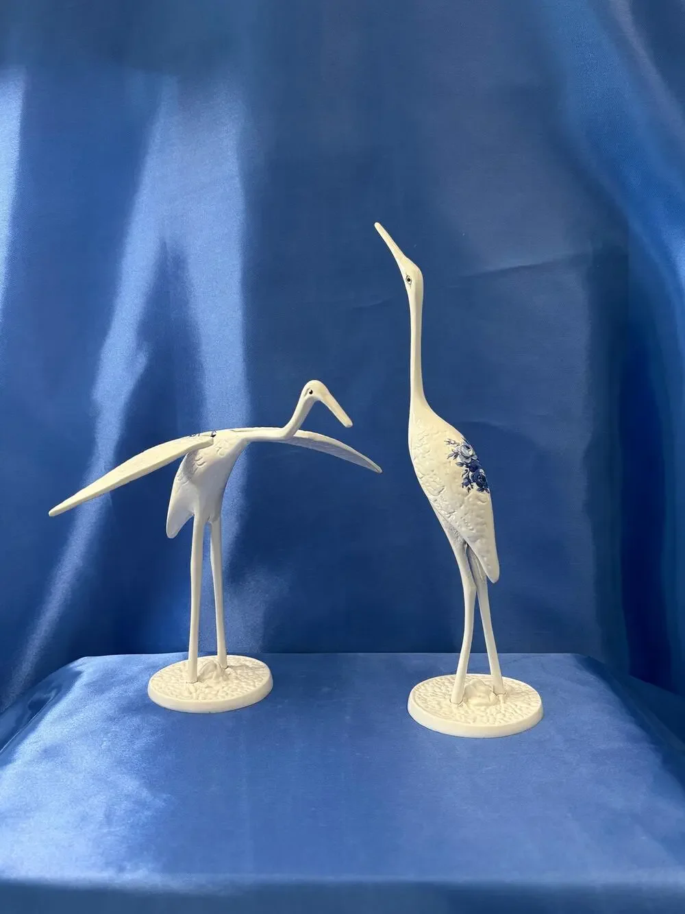 Pair of White Enamel Metal Cranes Accented with Blue Flower Design